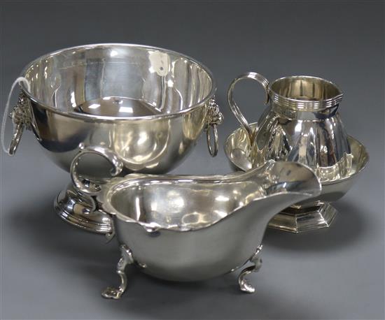 An Edwardian silver cream jug, a silver sauce boat, a silver sugar bowl and small silver rose bowl. 14.5 oz.